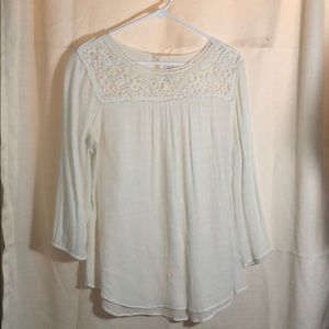 3/4 ivory colored blouse.